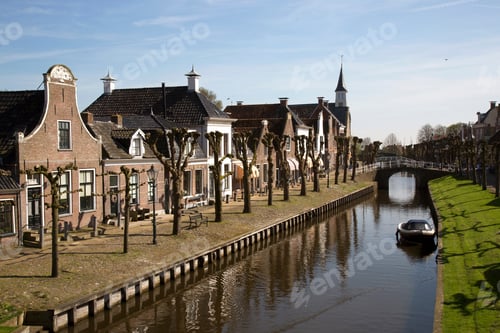 Preview: Typical Dutch Historic City Sloten With Old Houses, Canal, Courtyard With Special Pruning Lime Trees
