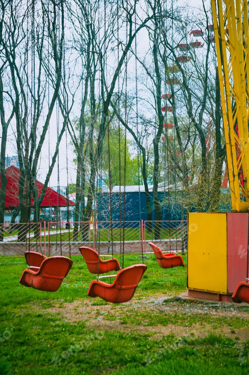 Preview: Empty Spring Old Amusement Park, Chain Swing Carousel Awaits Visitors, Filtered For Retro Effect