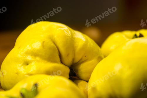 Preview: Large Yellow Quince Fruits On A Ceramic Plate, With Anise, Cinnamon, And Walnuts