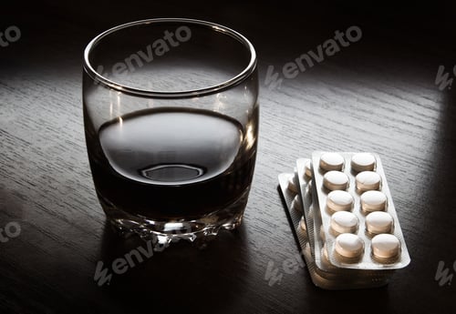 Preview: Glass Of The Whiskey With A Pills On The Table Closeup