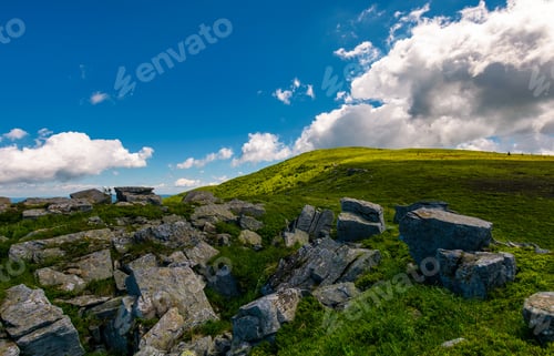 Preview: Giant Boulder On The Grassy Hillside. Beautiful Summer Landscape In Mountains. Fine Weather With
