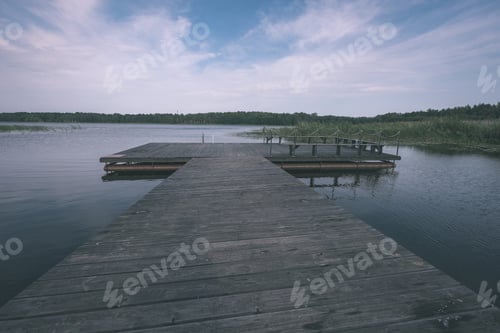 Preview: Wooden And Composite Material Foot Bridge Over Water In Green Summer Forest Surroundings With Lake