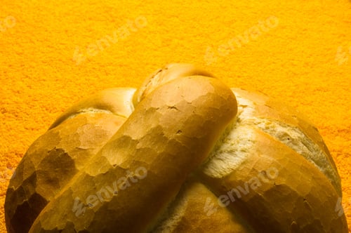 Preview: Fresh Braided Loaf Of White Wheat Bread On An Yellow Napkin