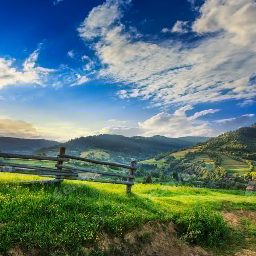 Preview: Wooden Fence In The Grass On The Hillside Near The Village