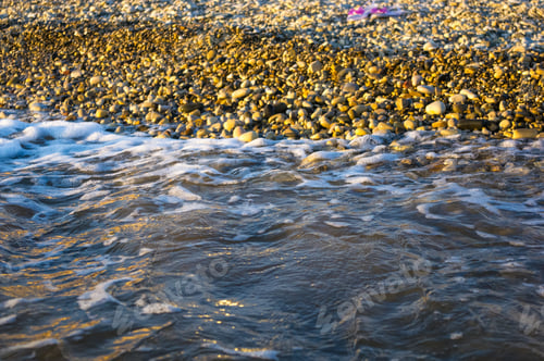 Preview: Sea Pebble Beach With Multicoloured Stones, Transparent Waves With Foam, On A Warm Summer Day
