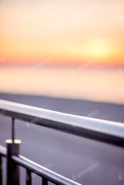 Preview: A Detail Of The Metal Iron Fence Of The Railing On The Beach Promenade At Sunset