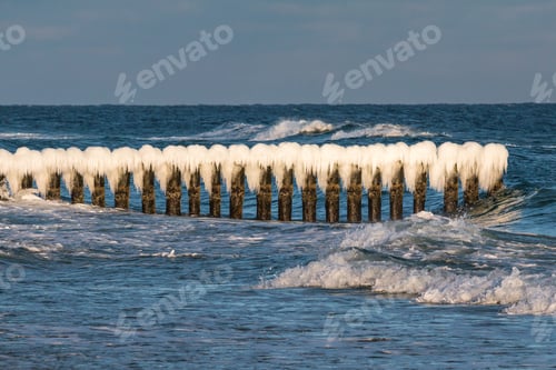 Preview: Winter Landscape At The Sea. Frozen Wooden Breakwaters Line At Baltic Sea. Morning At Chalupy