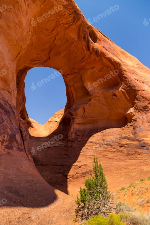 Preview: Ear If The Wind. Pothole Natural Arch Eroded In Sandstone. Navajo Tribal Park Of Monument Valley