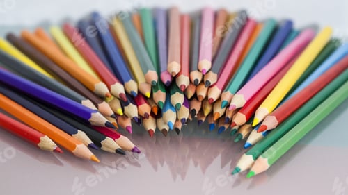 Preview: Group Of Sharp Colored Pencils With White And Red Background And Reflexions
