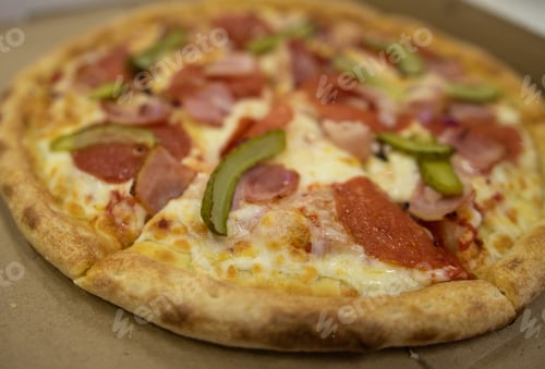 Preview: Big Pizza In A Box On The Table.