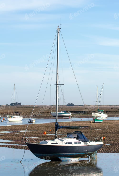 Preview: Small Sailing Boat Stranded At Low Tide At Wells Next The Sea, Norfolk, Uk