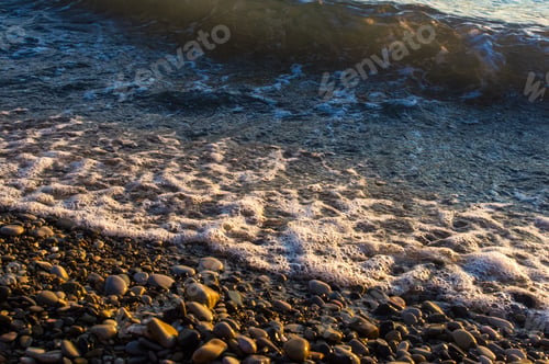 Preview: Sea Pebble Beach With Multicoloured Stones, Transparent Waves With Foam, On A Warm Evening