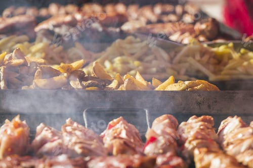 Preview: Different Kind On Grilled Meat, Sausages And Fried Potatoes With Smoke And Steam From De Grill