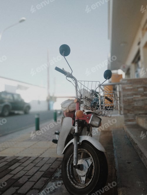 Preview: Old Motorcycle On A Sunny Town Street.