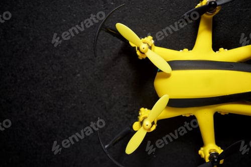 Preview: Yellow Drone On A Black Table.