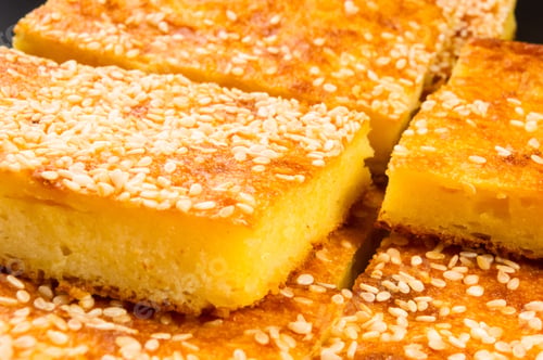 Preview: Slice Of Cheesecake With Sesame Seeds On A Black Background