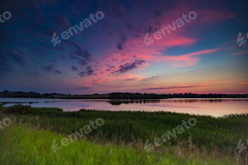 Preview: Beautiful Colorful Sunset Over Calm Lake Near City Olsztyn In Poland. Summertime Landscape With