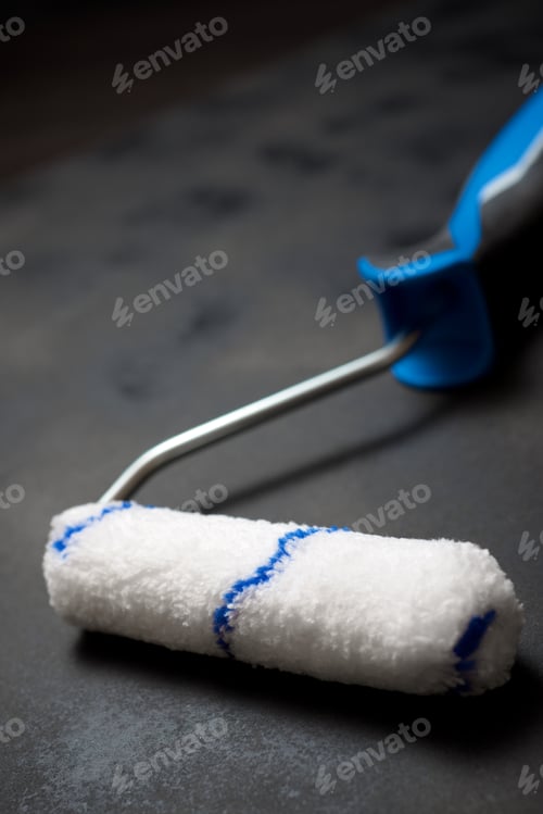 Preview: Paint Roller On A Black Table.