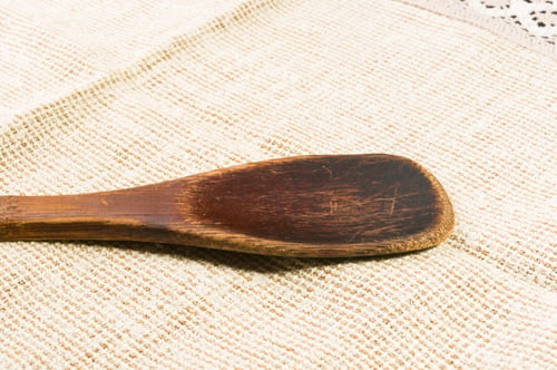Preview: Light Rustic Coarse Canvas Fabric And A Worn Wooden Spoon, Close-Up, Background
