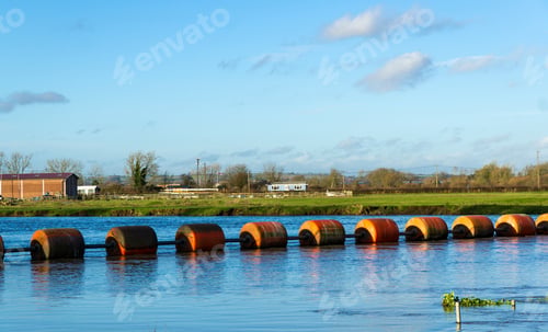 Preview: String Of Buoys Across A River