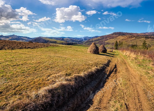 Preview: Stack Of Hay On Hillside Meadow Near The Road In Mountain Area In Early Spring