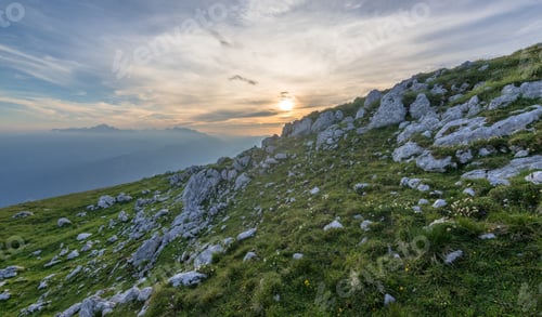 Preview: Walking On The Mountain Ridge With Flowers And Meadows At Sunset
