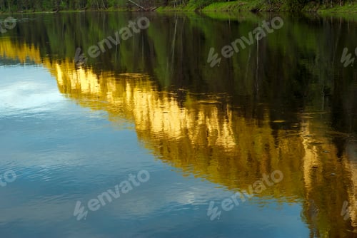 Preview: Water Surface Of The River With Reflected In It Wooded Coastal Cliffs, Lit By The Setting Sun