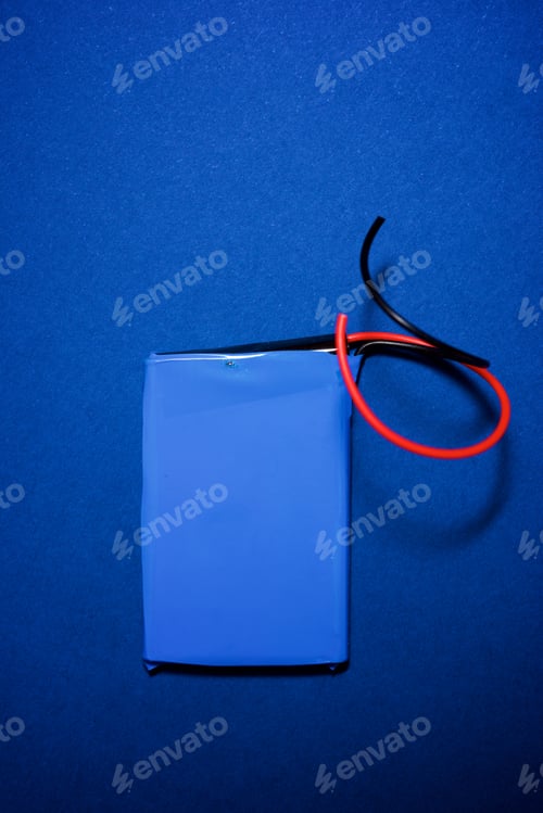 Preview: Small Battery On A Blue Table.