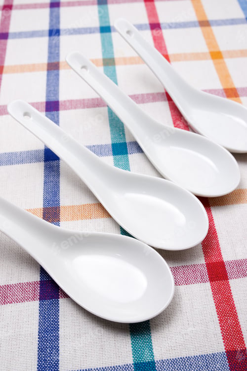 Preview: Small White Spoons On A White Tablecloth