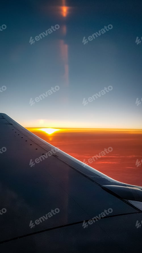 Preview: Sunset View From The Aeroplane Window Showing A Little Reflection And Flaring. Travel To Holiday On