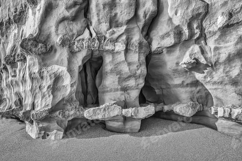 Preview: Weathered Joints In The Base Of A Sandstone Cliff At Hive Beach In West Dorset In Monochrome.