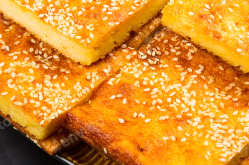 Preview: Slice Of Cheesecake With Sesame Seeds On A Black Background