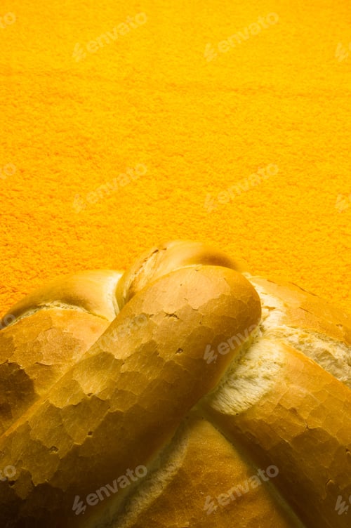 Preview: Fresh Braided Loaf Of White Wheat Bread On An Yellow Napkin
