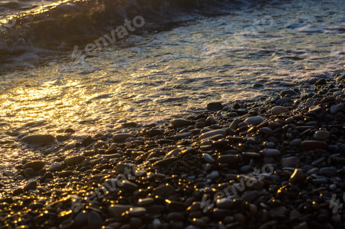 Preview: Sea Pebble Beach With Multicoloured Stones, Transparent Waves With Foam, On A Warm Evening