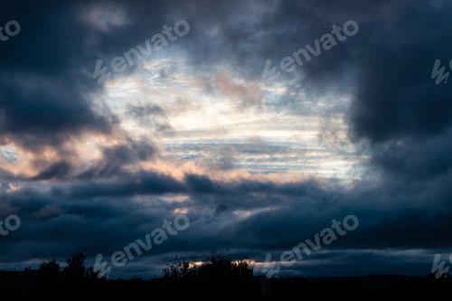 Preview: Dramatic Red And Black Clouds In Sunset Over City Rooftops