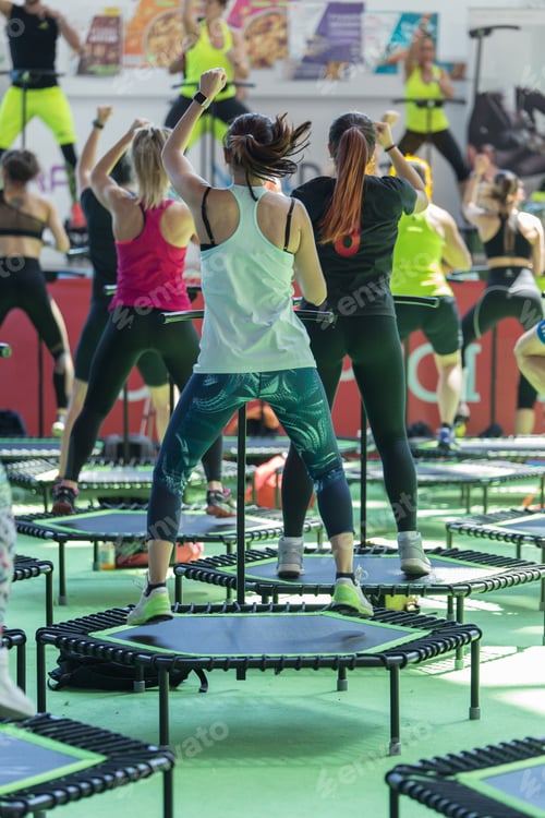 Preview: Mini Rebounder Workout - Girls Doing Fitness Exercise In Class At Gym With Music And Teacher On