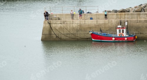 Preview: Small Fishing Boat Moored To A Harbour Seawall