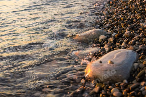 Preview: Sea Pebble Beach With Multicoloured Stones, Transparent Waves With Foam, On A Warm Evening