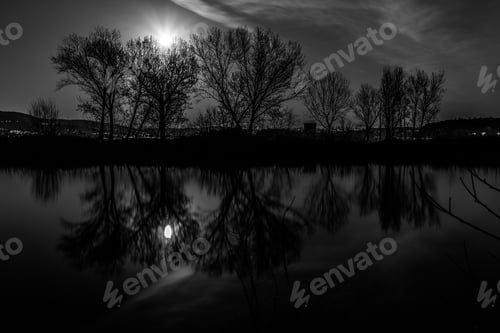 Preview: Moon And Trees Reflectiing On The Trasimeno Lake Surface At Night