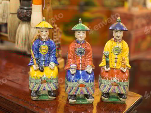 Preview: Colorful Decorative Figures Displayed on Wooden Surface
