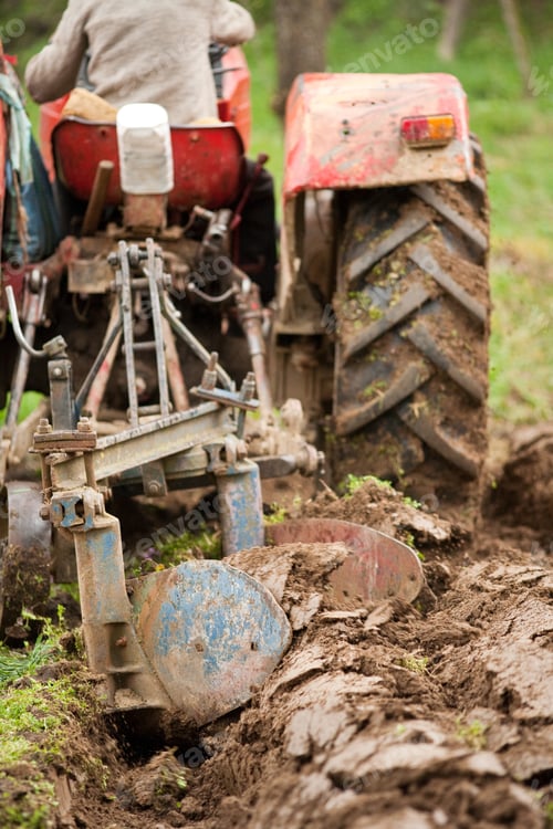 Preview: Close Up Of The Rear End Of A Tractor While Plowing, Some Motion Blur Present