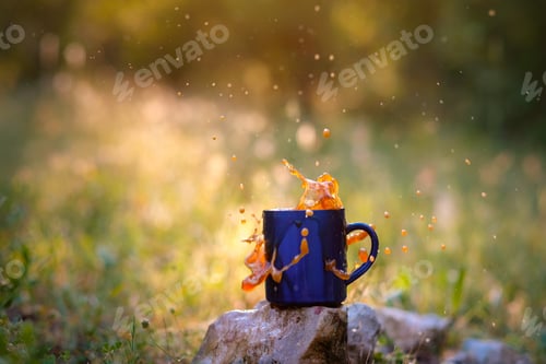 Preview: Blue Mug Of Hot Tea Or Coffee With Milk, Outdoor, The Concept Of Travel, Spray, Splash. Glare On