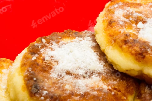 Preview: Red Plate Of Pancakes In Powdered Sugar On Black Background