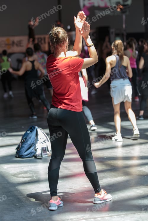 Preview: Fitness Workout In Gym: People Doing Exercises In Class With Music And Teacher On Stage.