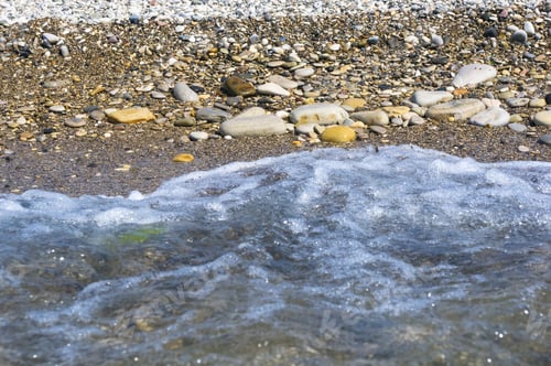 Preview: Sea Pebble Beach With Multicoloured Stones, Transparent Waves With Foam, On A Warm Summer Day