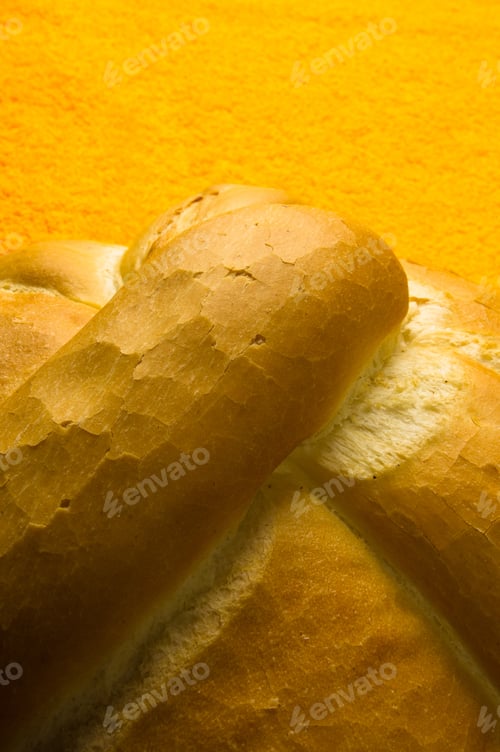 Preview: Fresh Braided Loaf Of White Wheat Bread On An Yellow Napkin