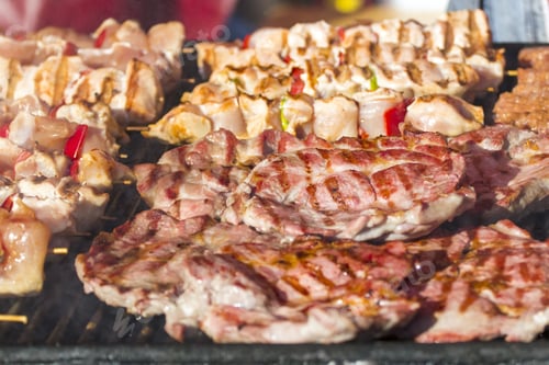 Preview: Different Kind On Grilled Meat And Sausages With Smoke And Steam From The Grill