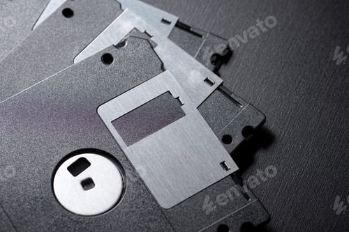 Preview: Old Floppy Disks On A Black Table.