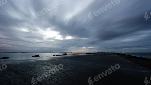 Preview: Night Clouds And Lights Above Industrial Port Of City Riga In Latvia. Nightfall
