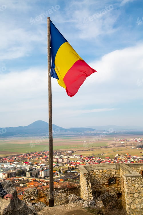 Preview: Romanian Flag Romanian Flag And Part Of Old Wall In Rasnov, Transylvania, Romania And Town At The